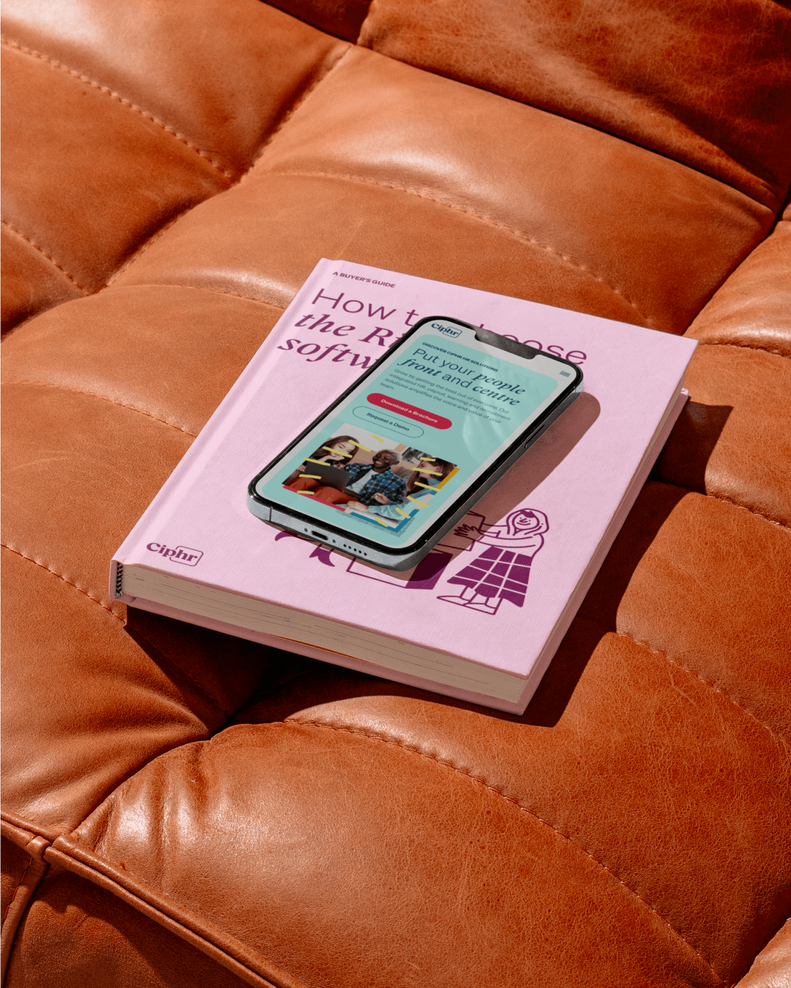Ciphr brand — 'How to Benchmark HR Software' book on an orange sofa