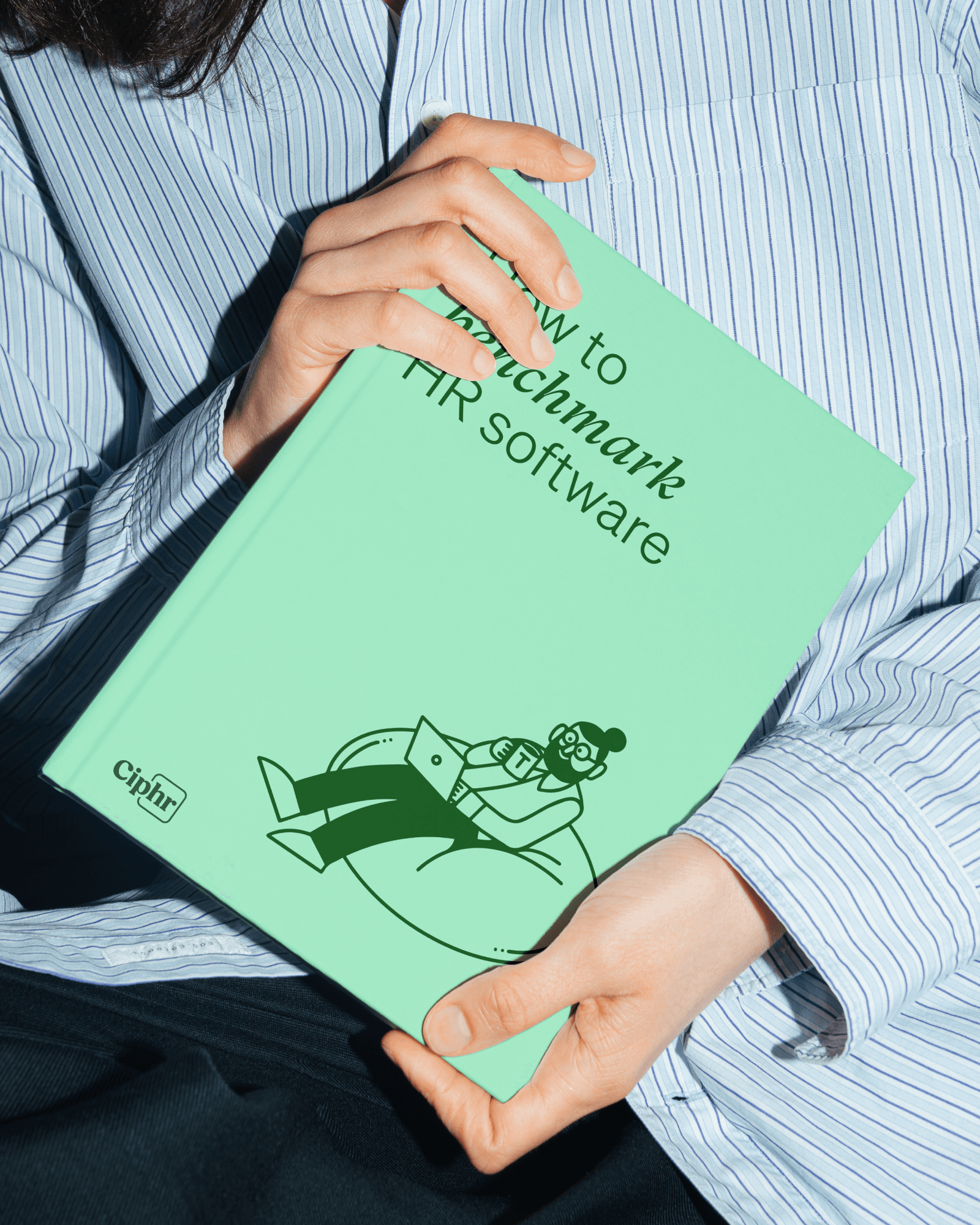 Ciphr brand — 'How to Benchmark HR Software' book held up